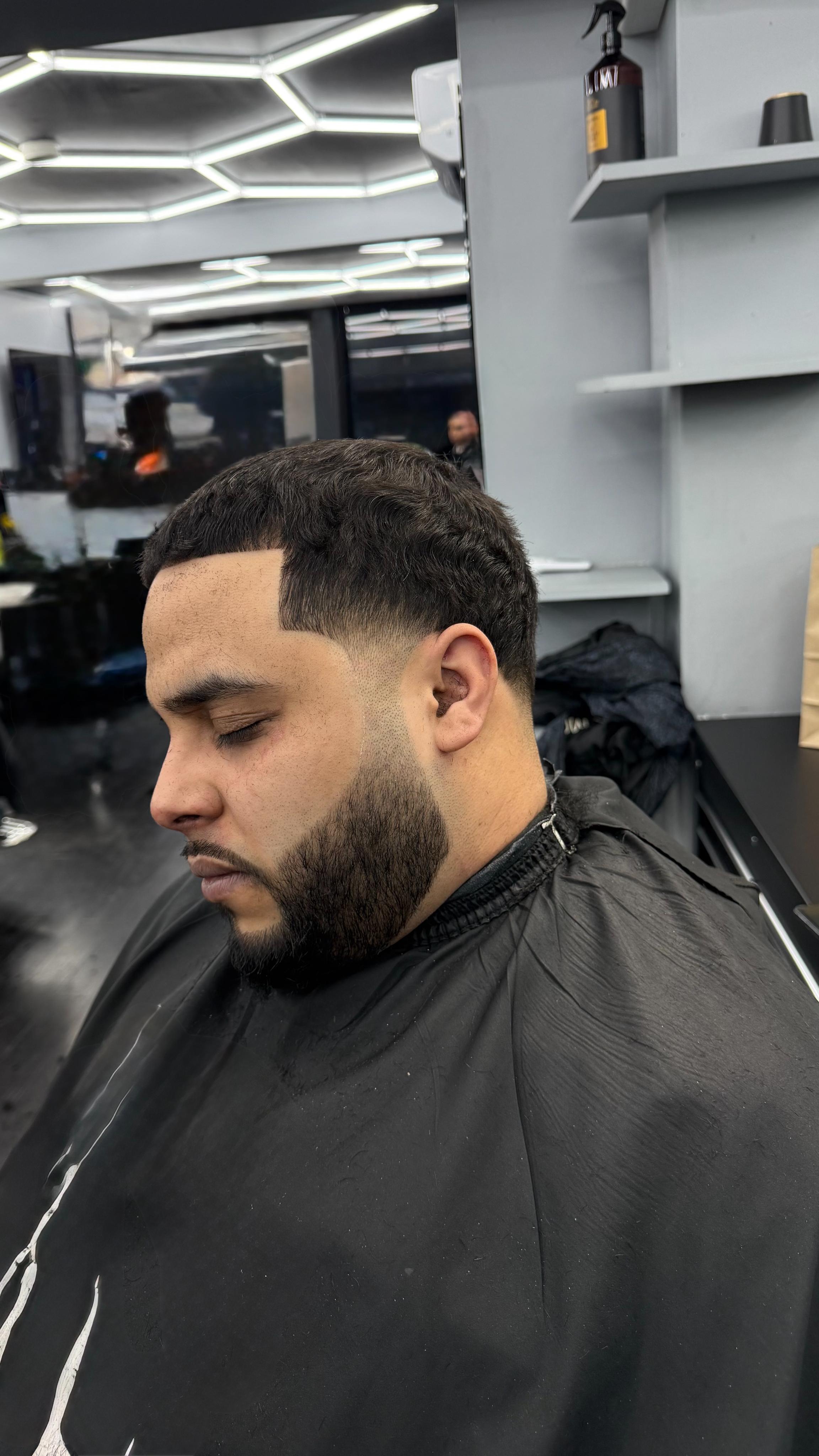 Low fade with beard sculpt